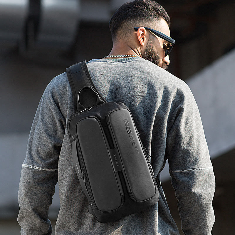 Tall Rugged Man's back with travel bag running down his shoulder and back